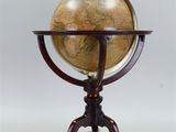 an antique globe on a stand with a wooden base