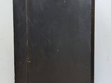 a black cabinet with a wooden top on a tile floor