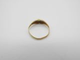 a close up of a gold ring on a white surface