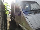 a white van that is parked next to a fence