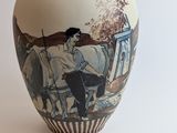a vase with a picture of a man on a horse drawn carriage
