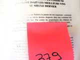 a book with a pink sticker on it and a red sticker on the page
