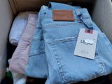 a box full of jeans with a tag on it