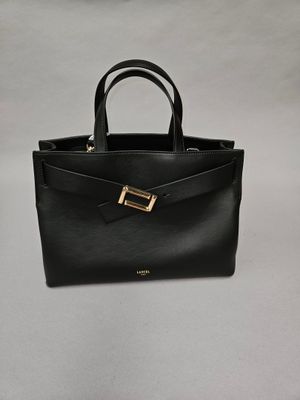 a black handbag with a gold buckle on the front