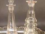 two glass chess pieces sitting on a silver tray