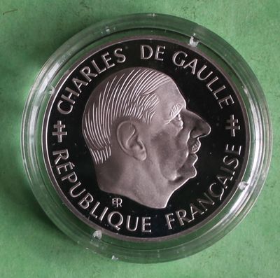 a close up of a silver coin with a man ' s face on it