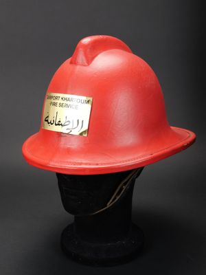 un casque de pompier rouge sur une tête de mannequin noire