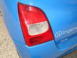 a close up of a blue car with a sticker on it