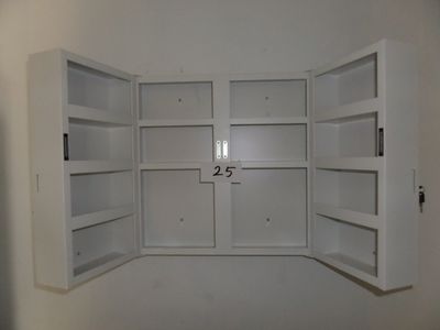 a picture of a white cupboard with two open doors