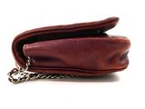 leather wallet with chain hanging from it ' s side on a white surface