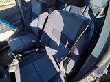 the interior of a car with a seat belt and a steering wheel