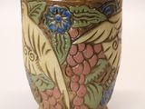 a vase that has a bird and flowers on it