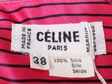 pink and black striped shirt with white label on it