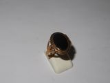 an image of a gold ring with a black stone on it
