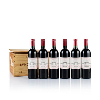 six bottles of red wine in a wooden box next to a wooden box