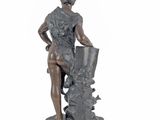 statue of a woman sitting on a rock holding a vase