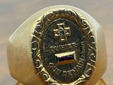 an image of a gold ring with a seal on it