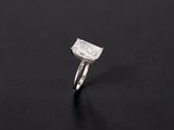 a white gold ring with a square cut diamond on a black background