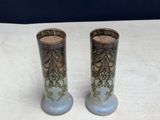 two vases that are sitting on a table