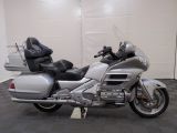 a silver motorcycle that is parked in a garage