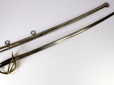 pair of antique swords on a white surface with a hook