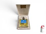 an open box with a bottle of perfume in it on a white surface