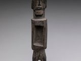 an image of a statue of a man standing on a wooden base