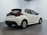 the back of a white car is parked in a room