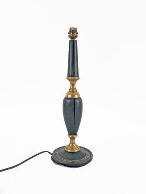 a black and gold table lamp with a black base