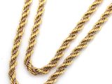 a close up of a gold rope necklace on a white background