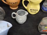 many different types of jugs and pitchers on the table