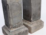 two cement blocks sitting next to each other on a white surface