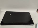 a black laptop computer sitting on a white table