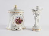 two figurines sitting next to each other on a white surface