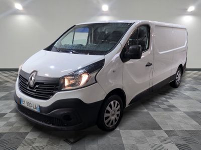 la camionnette blanche est garée sur un sol carrelé en damier