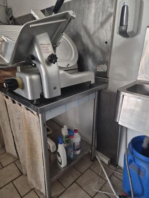 a machine that is sitting in a kitchen next to a trash can