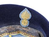 a blue hat with a gold emblem on it