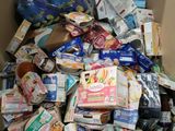 a cardboard box full of food and drinks in it