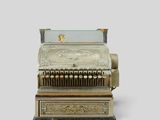 a silver cash register sitting on top of a table