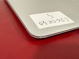 a sticker on the back of a laptop on a table