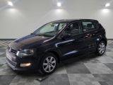 the black volkswagen polo estate is parked on a checkered tile floor