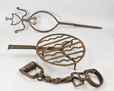 two old metal items that are sitting on a white surface