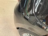 a close up of a car ' s rear end with the door open