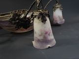 two vases with flowers in them sitting on a table