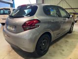 a silver car parked in a garage with other cars