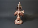 an image of a figurine of a man holding a flower