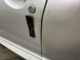 a close up of a car door with a sticker on it