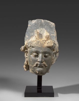 an image of a head of a man wearing a headdress