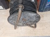 a metal object that is sitting on the floor next to a drain