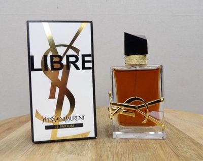 a close up of a bottle of perfume on a table